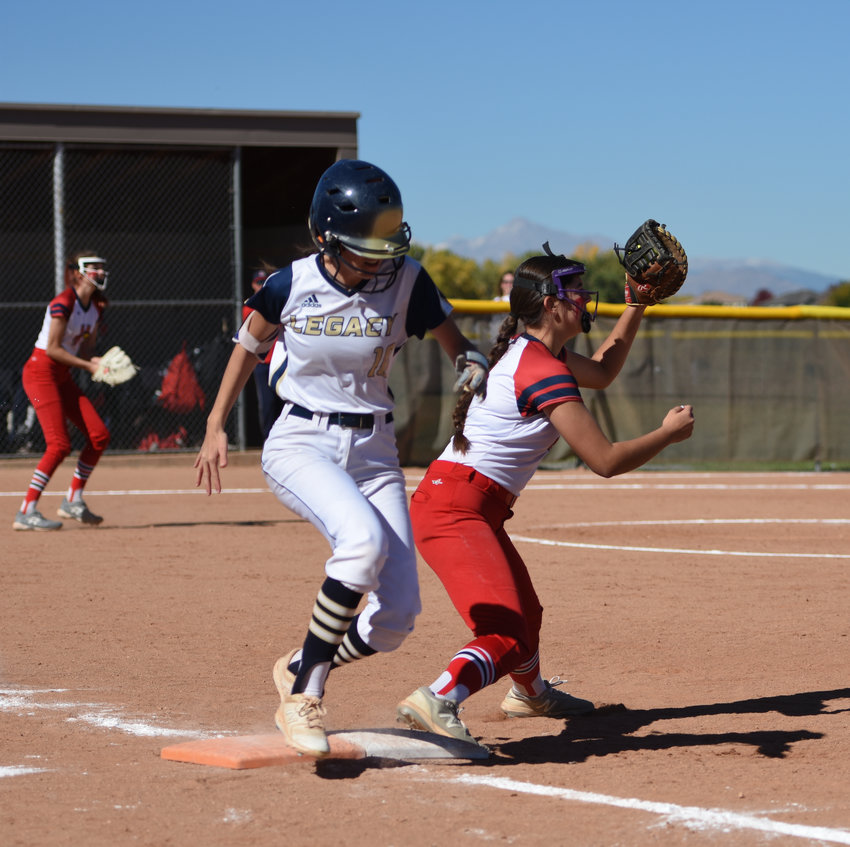 Legacy's Reese Mansur, left, is thrown out on a close play at first base against Heritage in a CHSAA 5A first round regional playoff game at Legacy High School Oct. 16. The Lightning beat Heritage and Cherokee Trail to advance to the state tournament this week.